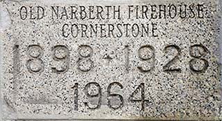 gray flecked granite stone inscribed 'Old Narberth Firehouse cornerstone 1898-1928-1964'