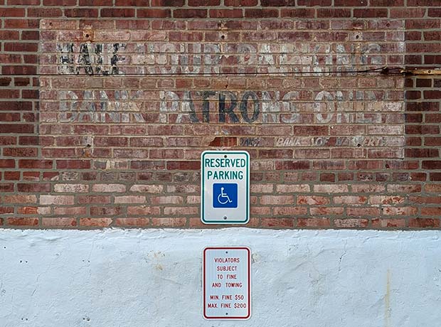 faded sign on brick wall