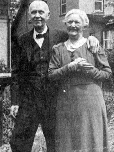 three-quarters length, smiling, older couple, his arm around her, eyes closed