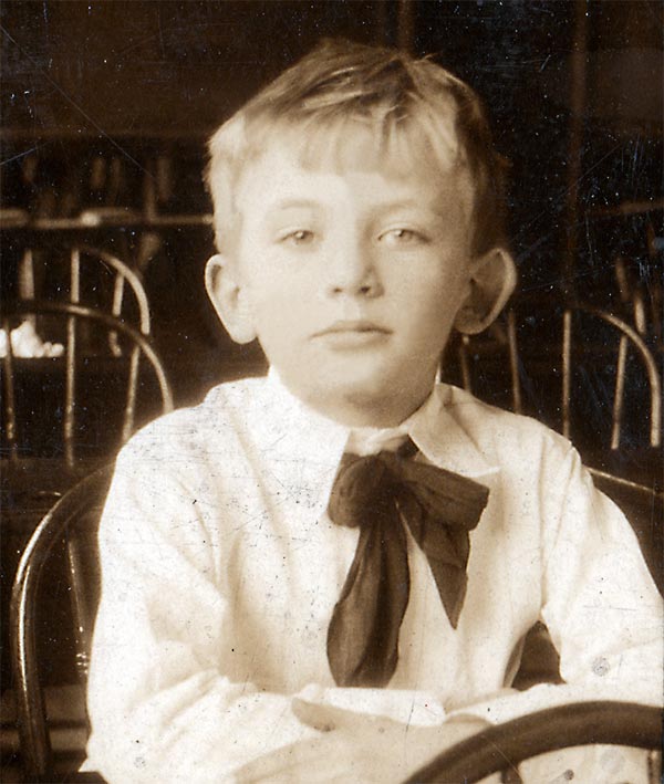 6-year-old boy with floppy neck bowtie and confident gaze