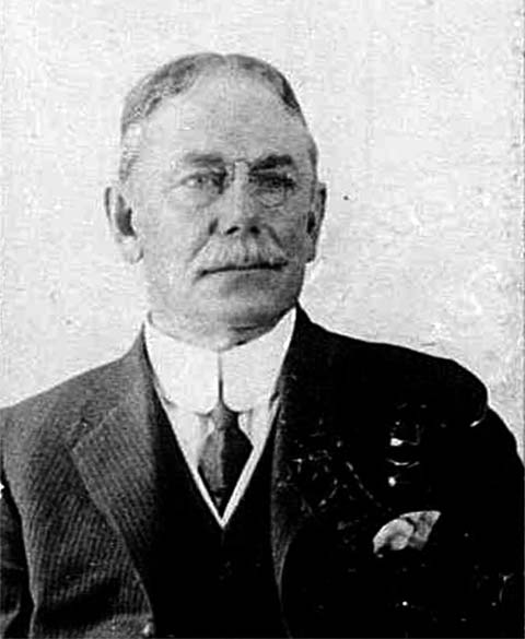 older mustached man in tie, starched collar