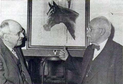 2 old men flank a painting of a horse