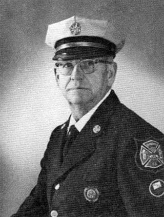 older man in fire chief uniform, hat