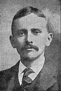 head and shoulders of a slight young man with mustache, jacket, tie