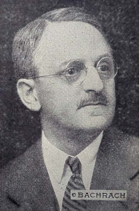 middle aged man with mustache, round wire framed glasses